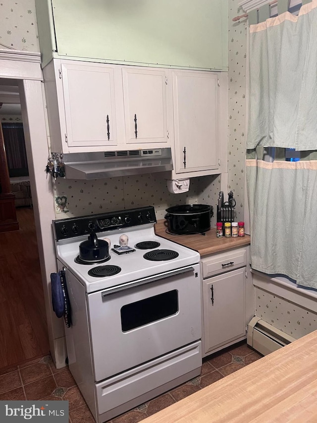 kitchen featuring white cabinetry, dark tile patterned flooring, a baseboard radiator, and white range with electric stovetop