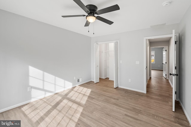 unfurnished bedroom featuring ceiling fan and light wood-type flooring