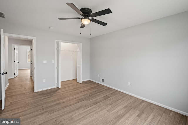 unfurnished bedroom with a closet, ceiling fan, and light wood-type flooring