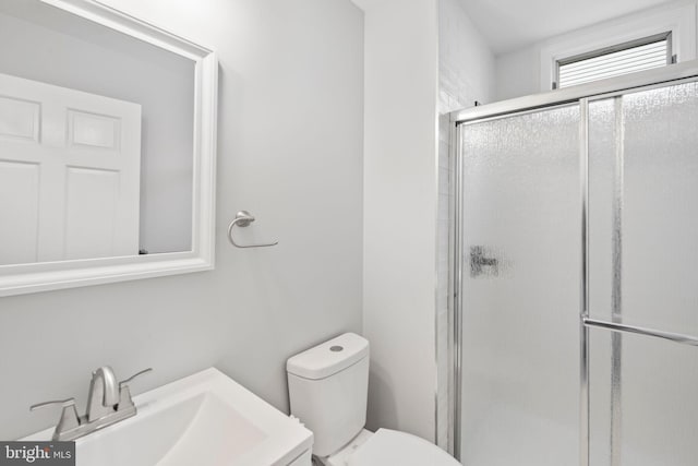 bathroom with walk in shower, vanity, and toilet