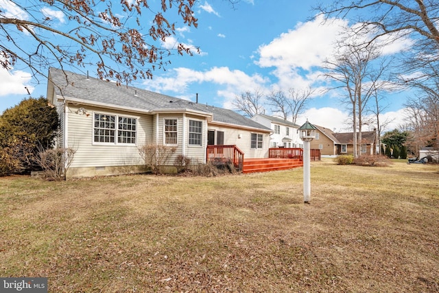 back of property featuring a yard and a deck