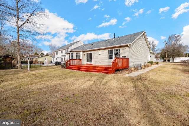 rear view of property featuring a yard, a deck, and central air condition unit