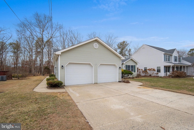 view of side of property with a garage, a yard, and cooling unit