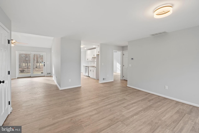 unfurnished living room featuring ceiling fan and light wood-type flooring