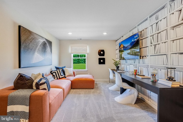 carpeted home office featuring built in desk