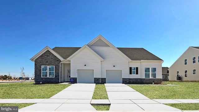 craftsman house with a garage, central AC, and a front yard