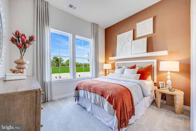 bedroom featuring light carpet