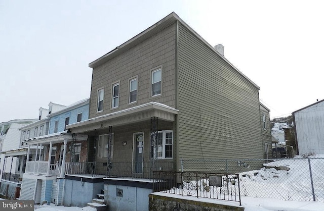 view of snow covered exterior featuring covered porch