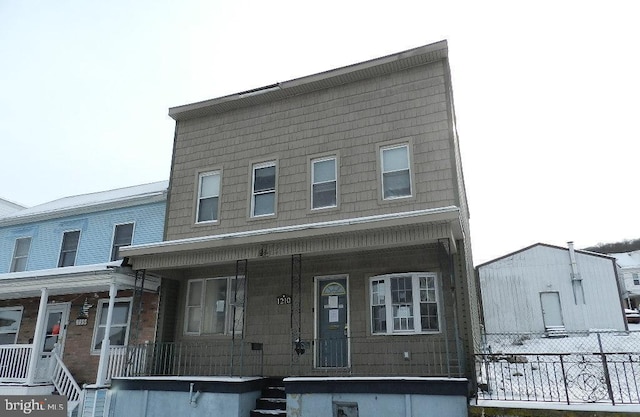 townhome / multi-family property featuring covered porch