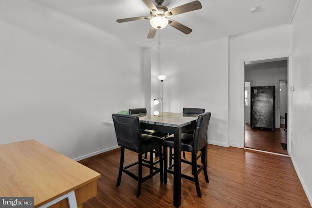 dining area with ceiling fan and dark hardwood / wood-style flooring