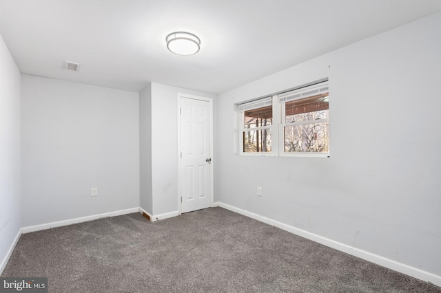 unfurnished bedroom with dark colored carpet