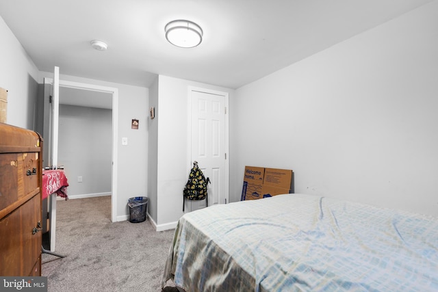 bedroom with light carpet and a closet