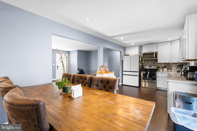 dining space with dark hardwood / wood-style floors