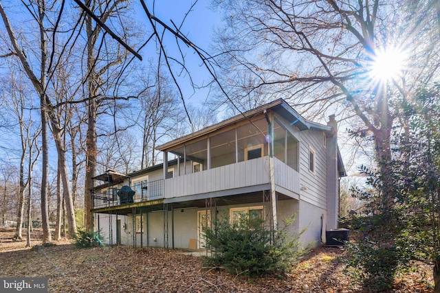 exterior space featuring central AC unit and a sunroom