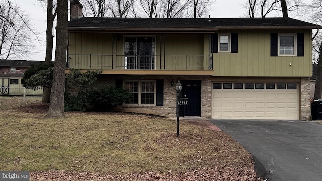 view of front of property with a garage and a balcony