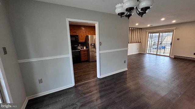 interior space with a baseboard heating unit, dark hardwood / wood-style floors, and a chandelier