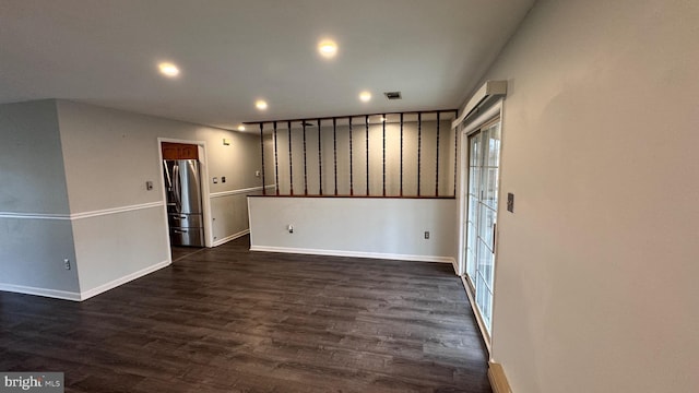 spare room featuring dark hardwood / wood-style flooring