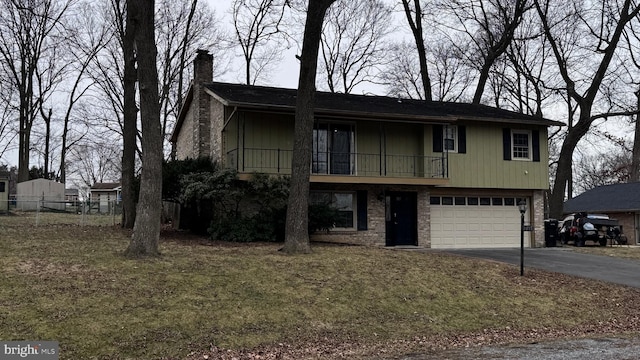 view of front of home with a garage and a front yard