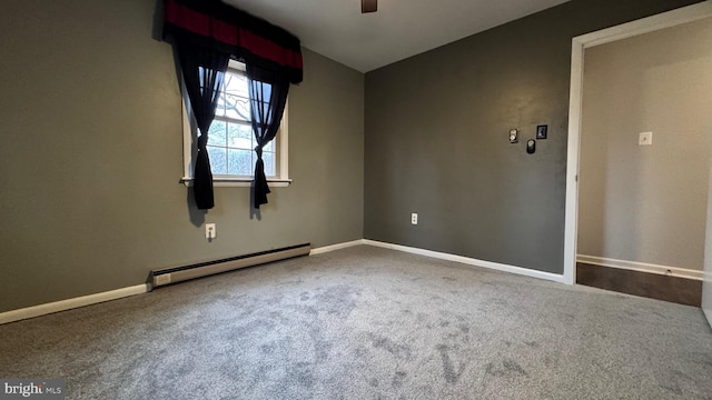 carpeted empty room featuring vaulted ceiling, ceiling fan, and baseboard heating