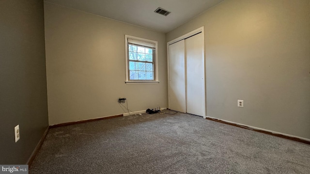 unfurnished bedroom featuring a closet and carpet flooring