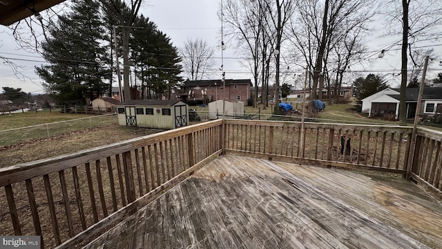 wooden terrace featuring a shed