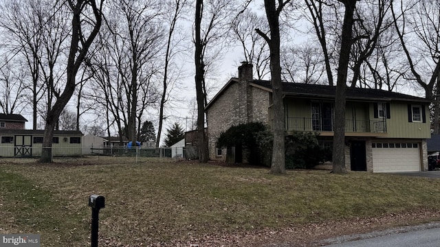 view of front of property featuring a garage and a front lawn