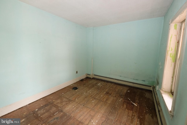 spare room featuring baseboard heating and baseboards