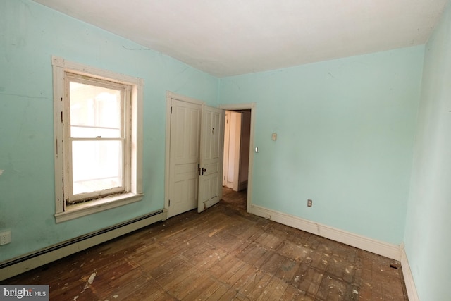 unfurnished bedroom featuring baseboards and a baseboard heating unit