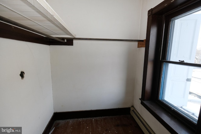 spacious closet with baseboard heating and wood finished floors