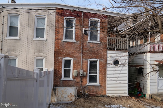 exterior space with fence and brick siding