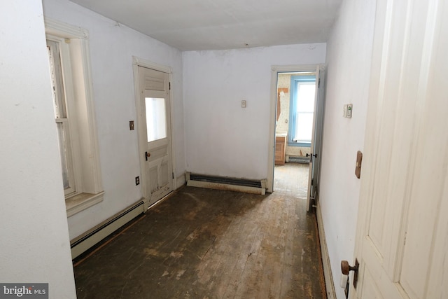 hall featuring a baseboard heating unit and wood-type flooring