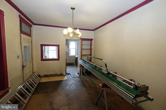 recreation room featuring a notable chandelier and crown molding