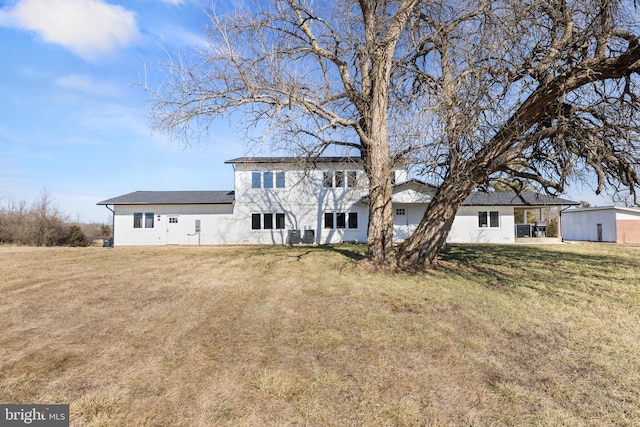 rear view of property with a lawn