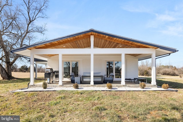 back of house with a yard and a patio area