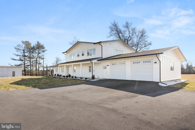 view of front of home with a garage and a front lawn