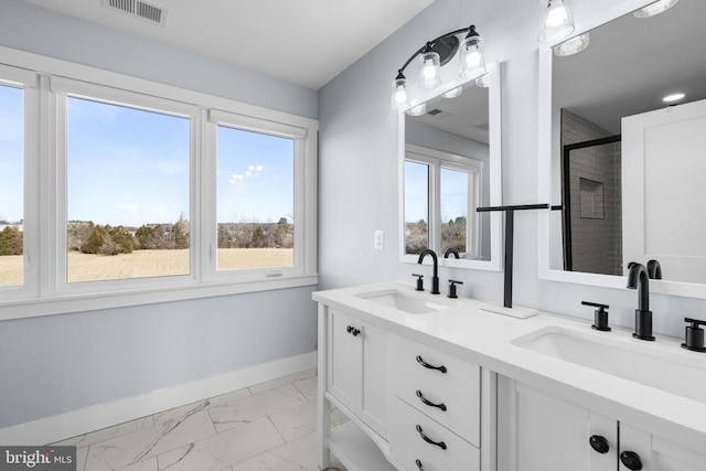 bathroom featuring vanity and a shower with door