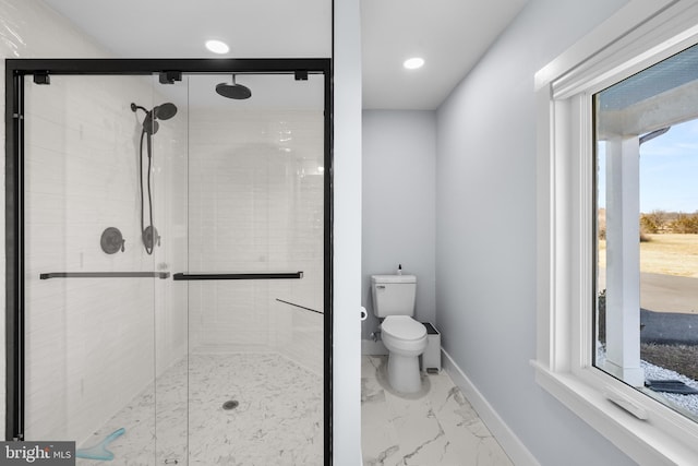 bathroom featuring an enclosed shower and toilet