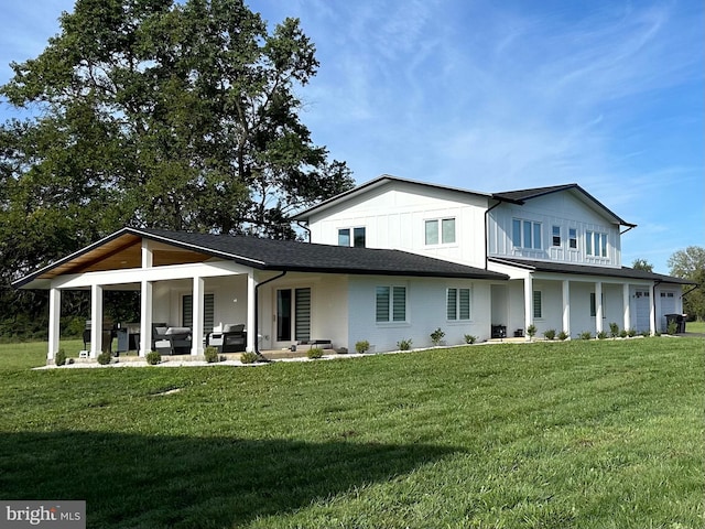 rear view of property with a lawn