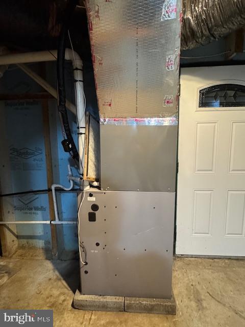 utility room with heating unit