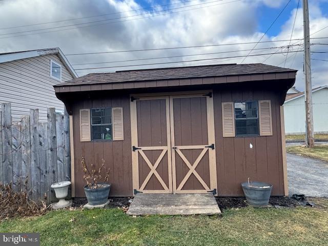 view of outbuilding featuring a yard