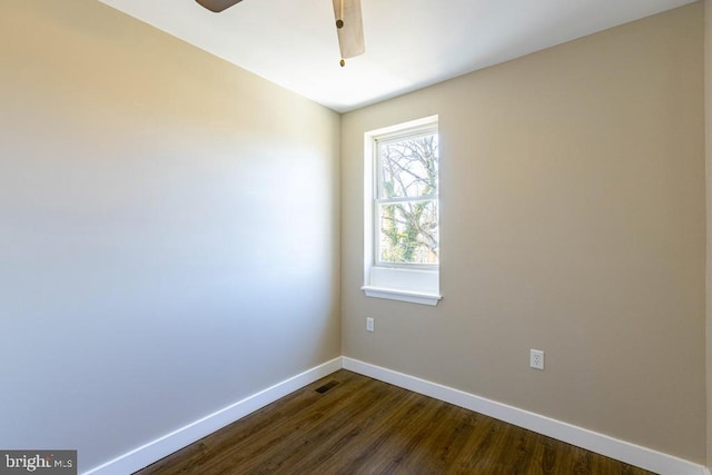 unfurnished room with dark hardwood / wood-style floors and ceiling fan