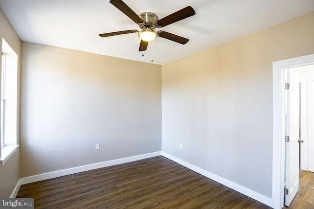 unfurnished room featuring a wealth of natural light, dark hardwood / wood-style floors, and ceiling fan