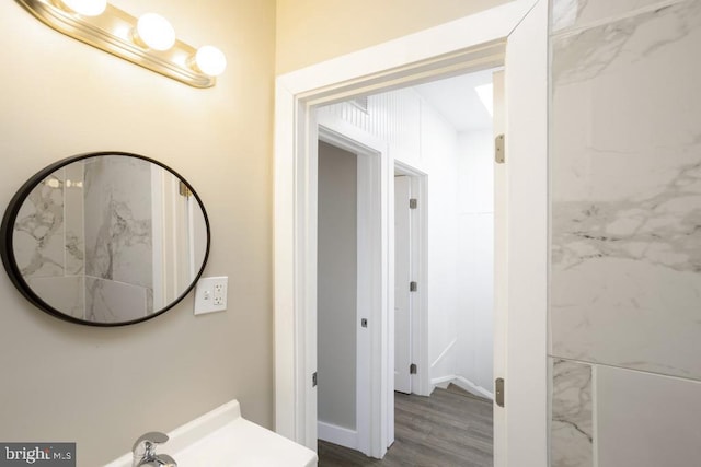 bathroom with hardwood / wood-style floors