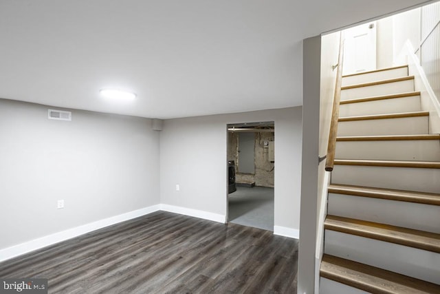 basement featuring dark hardwood / wood-style flooring