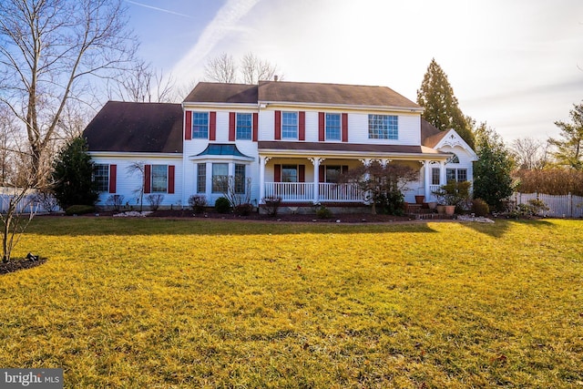 view of front of home featuring covered porch and a front lawn