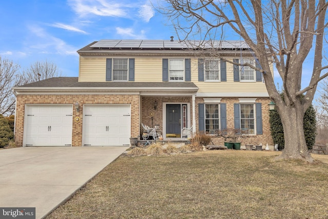 view of front of house with a garage, a front yard, and solar panels