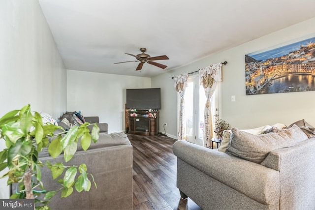 living room featuring dark hardwood / wood-style flooring and ceiling fan