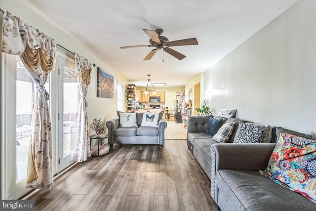 living room with hardwood / wood-style floors and ceiling fan