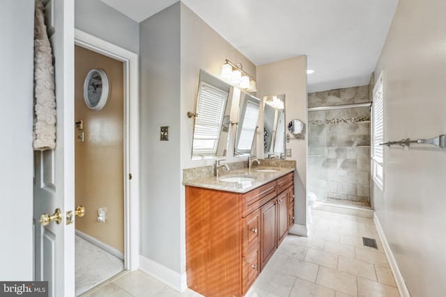 bathroom featuring tile patterned floors, vanity, toilet, and an enclosed shower