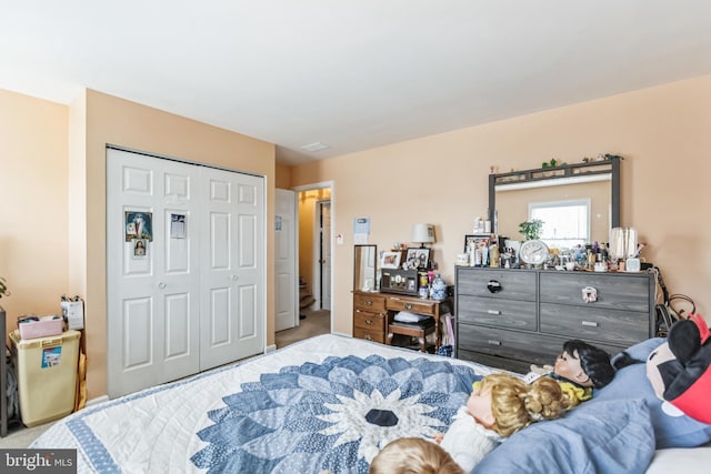 carpeted bedroom featuring a closet